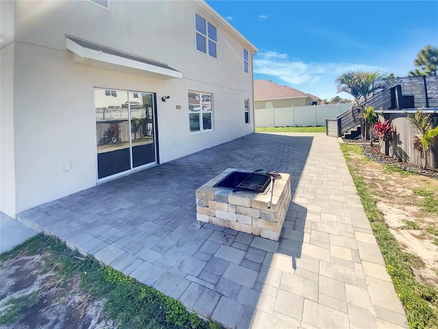 view of patio / terrace with fence and an outdoor fire pit