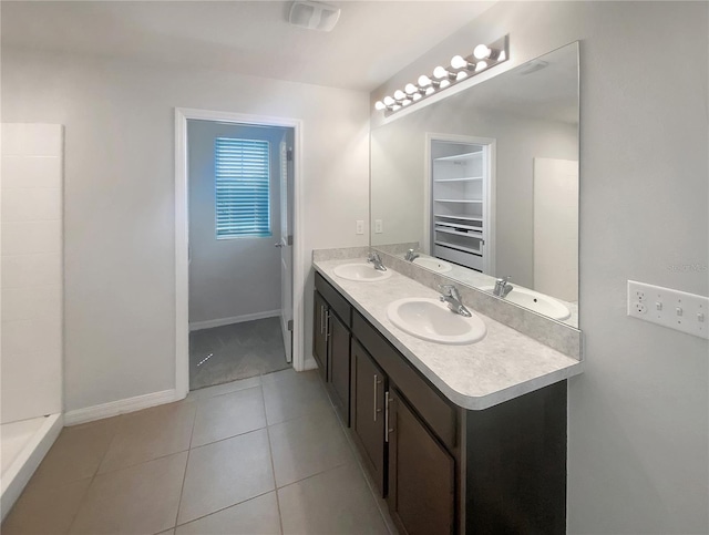 bathroom featuring double vanity, visible vents, and a sink