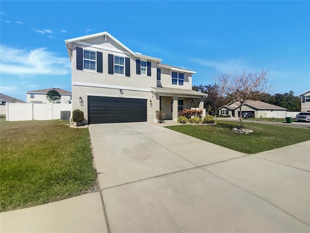 view of front of property featuring a front yard, fence, an attached garage, stucco siding, and concrete driveway