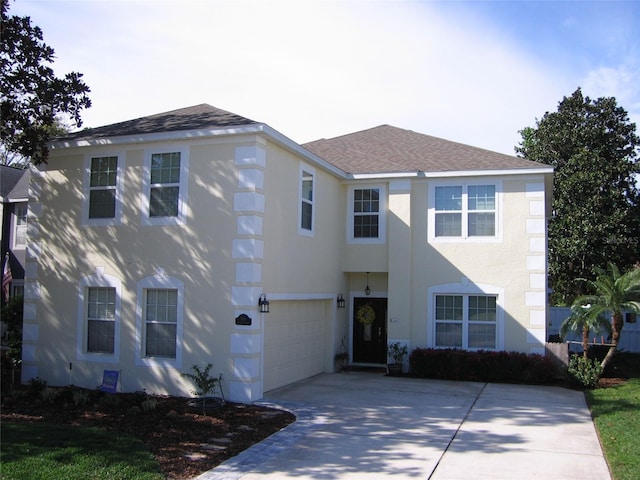 view of front facade featuring a garage, stucco siding, driveway, and roof with shingles