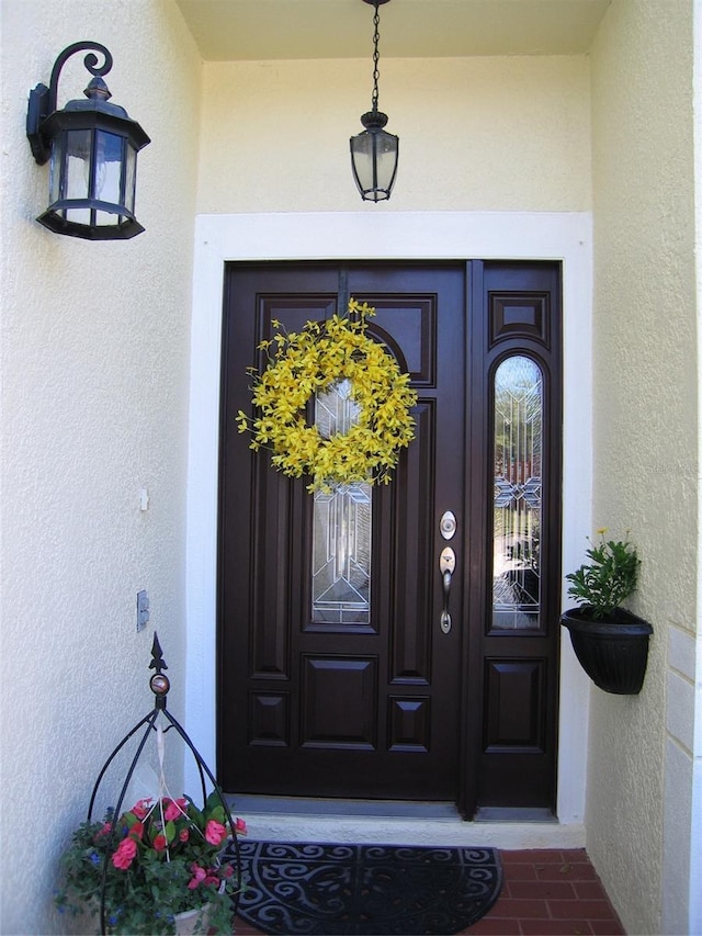 entrance to property with stucco siding