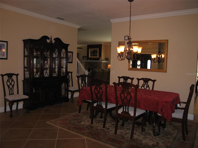 dining room with tile patterned flooring, visible vents, a chandelier, and ornamental molding