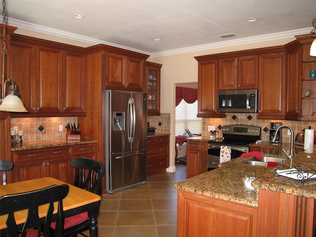 kitchen featuring tile patterned floors, visible vents, a sink, backsplash, and appliances with stainless steel finishes