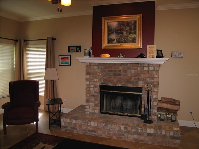 living area with crown molding, a brick fireplace, baseboards, and tile patterned floors