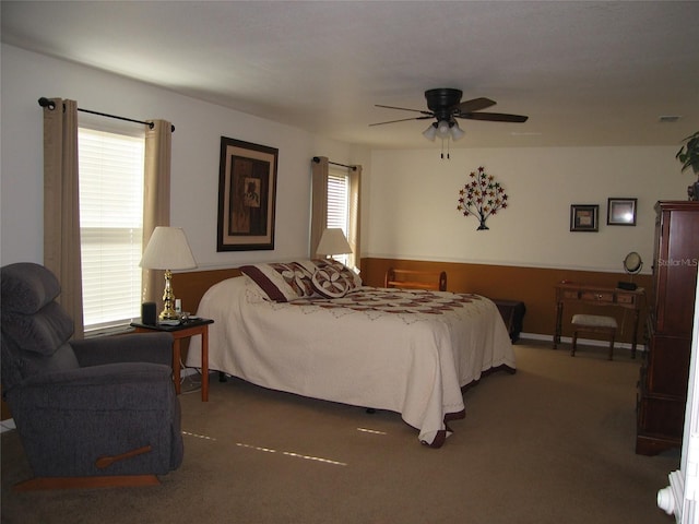 bedroom with visible vents, multiple windows, ceiling fan, and carpet flooring