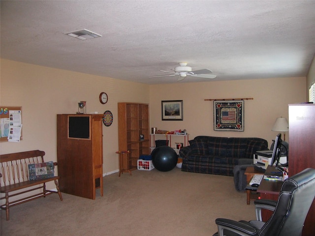 carpeted living room with visible vents, a textured ceiling, and ceiling fan