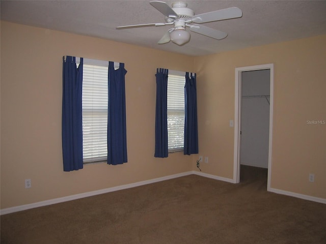 spare room featuring baseboards, ceiling fan, and carpet flooring