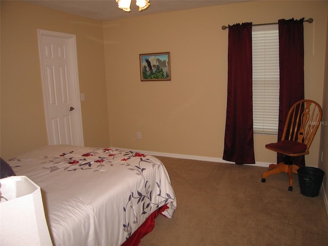 carpeted bedroom featuring baseboards