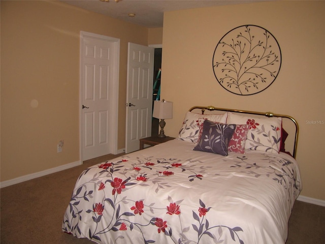 bedroom featuring carpet and baseboards