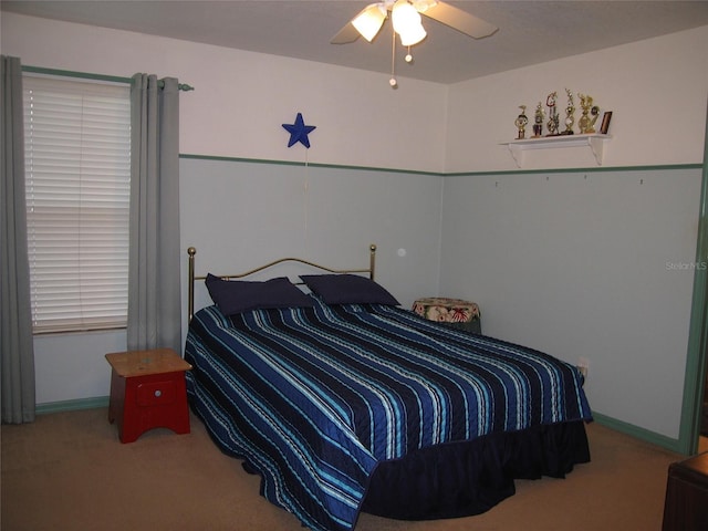 bedroom featuring baseboards, a ceiling fan, and carpet