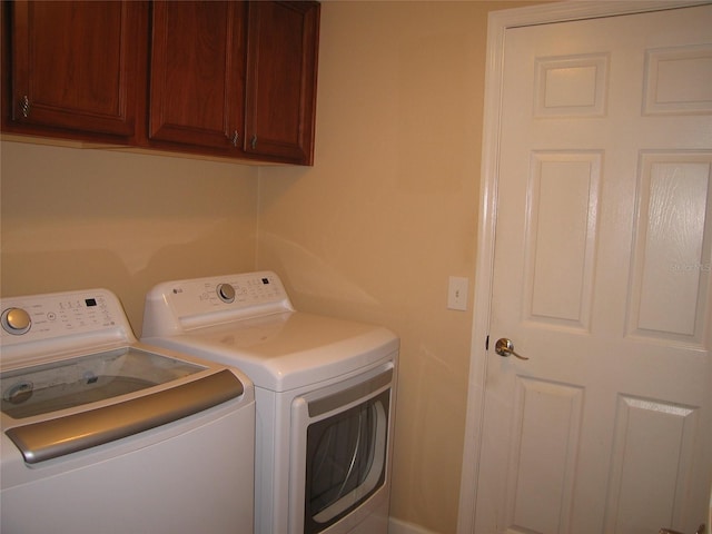 laundry area with cabinet space and separate washer and dryer