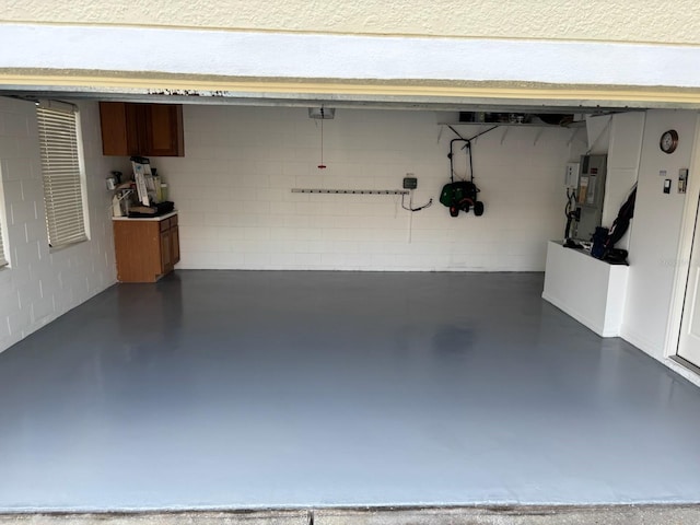 garage with concrete block wall