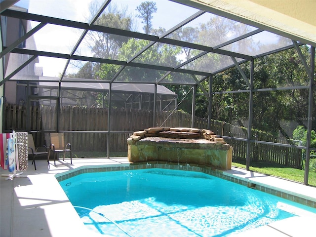 view of pool with a patio area, a fenced in pool, glass enclosure, and fence