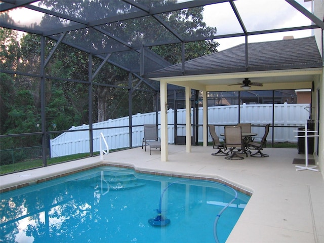 view of pool with glass enclosure, a patio area, fence, and a fenced in pool