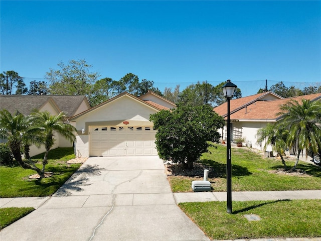 view of front of property featuring stucco siding, driveway, an attached garage, and a front yard