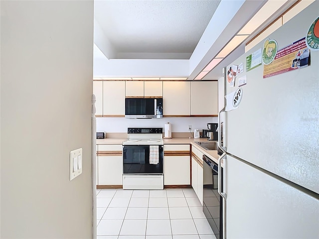 kitchen with white appliances, white cabinets, light tile patterned floors, and light countertops