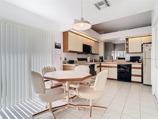 kitchen featuring visible vents, black dishwasher, electric range oven, freestanding refrigerator, and light countertops