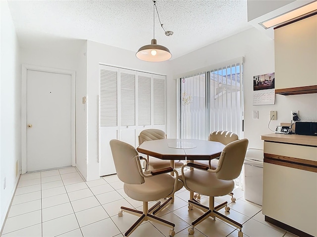 dining room featuring light tile patterned floors, a textured ceiling, and a wall mounted AC