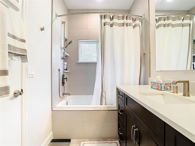 bathroom with vanity and tiled shower / bath