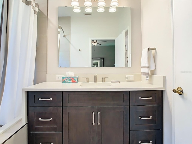 bathroom featuring a shower with shower curtain, visible vents, ceiling fan, and vanity