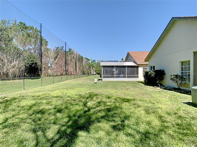 view of yard with fence and a sunroom