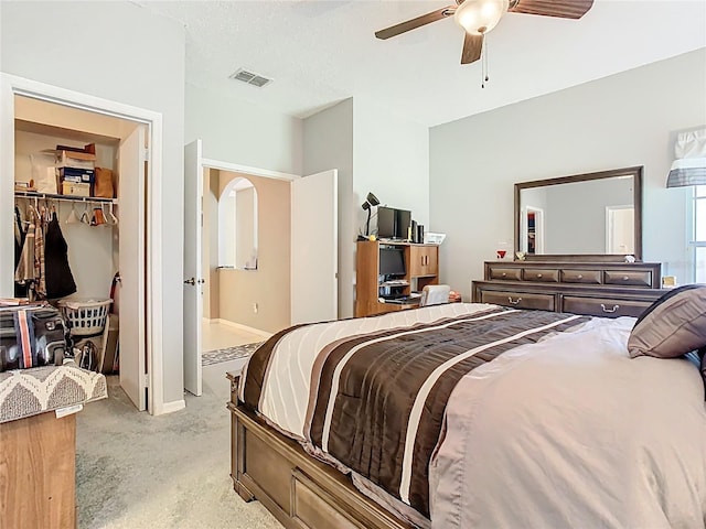 bedroom featuring light carpet, visible vents, baseboards, and a ceiling fan