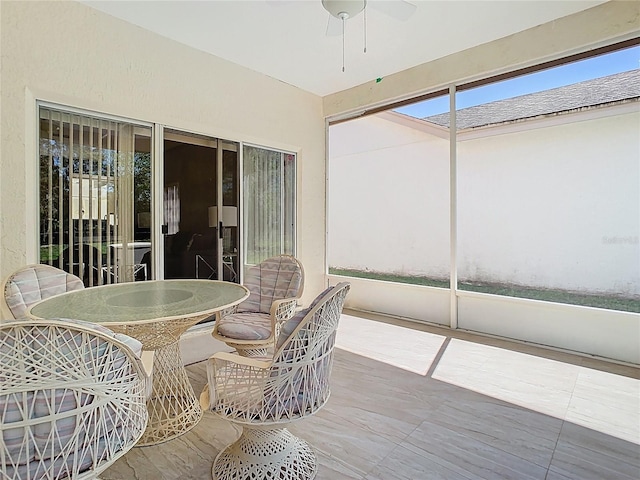 sunroom / solarium featuring ceiling fan