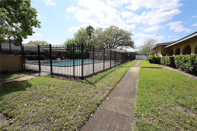 pool featuring a lawn and fence