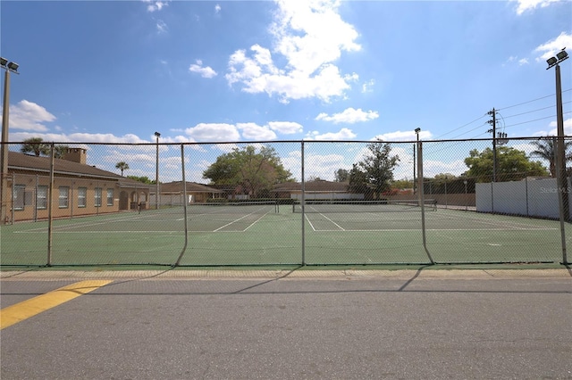 view of sport court featuring fence