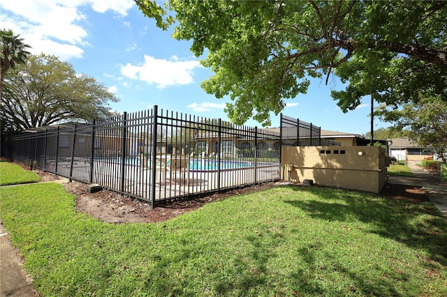 pool with a lawn and fence