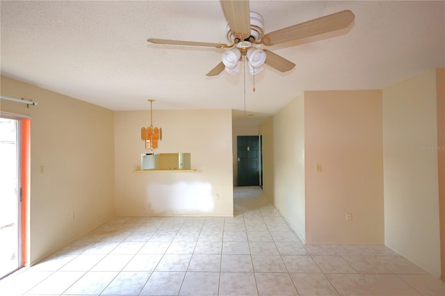 empty room with light tile patterned floors, a textured ceiling, and ceiling fan