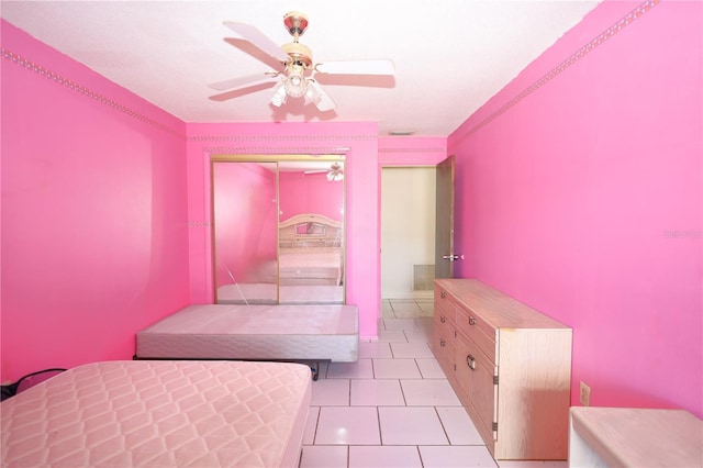 bedroom featuring ceiling fan, visible vents, a closet, and light tile patterned flooring