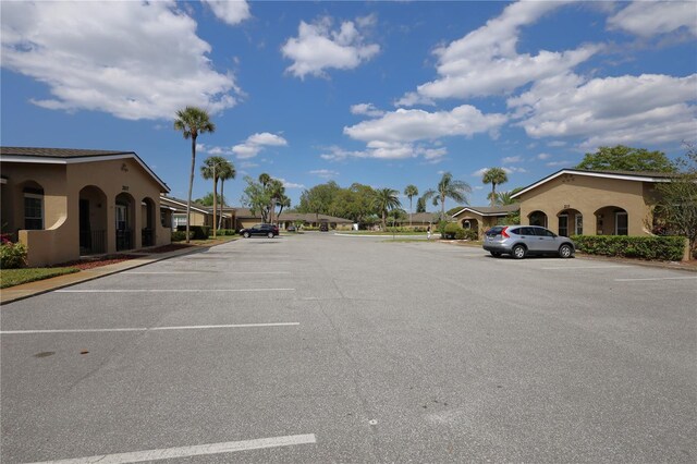 uncovered parking lot featuring a residential view