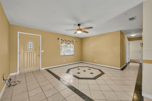 foyer with light tile patterned floors, baseboards, and a ceiling fan