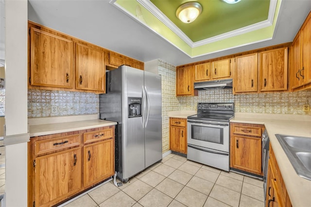 kitchen featuring under cabinet range hood, light tile patterned floors, appliances with stainless steel finishes, and a raised ceiling