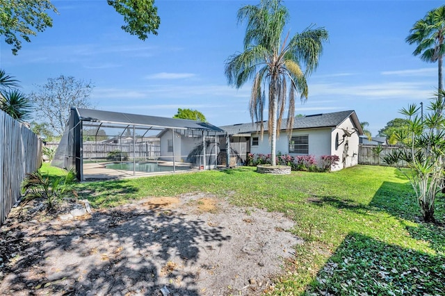 view of yard featuring a lanai, a fenced in pool, and a fenced backyard