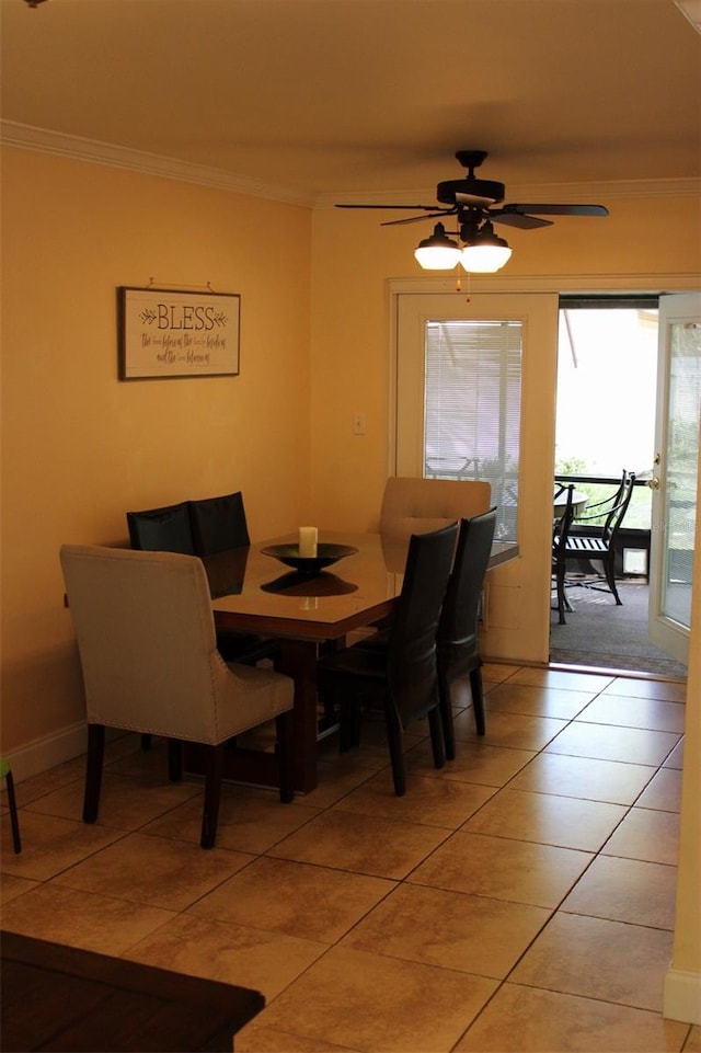 dining area featuring light tile patterned floors, a ceiling fan, and crown molding