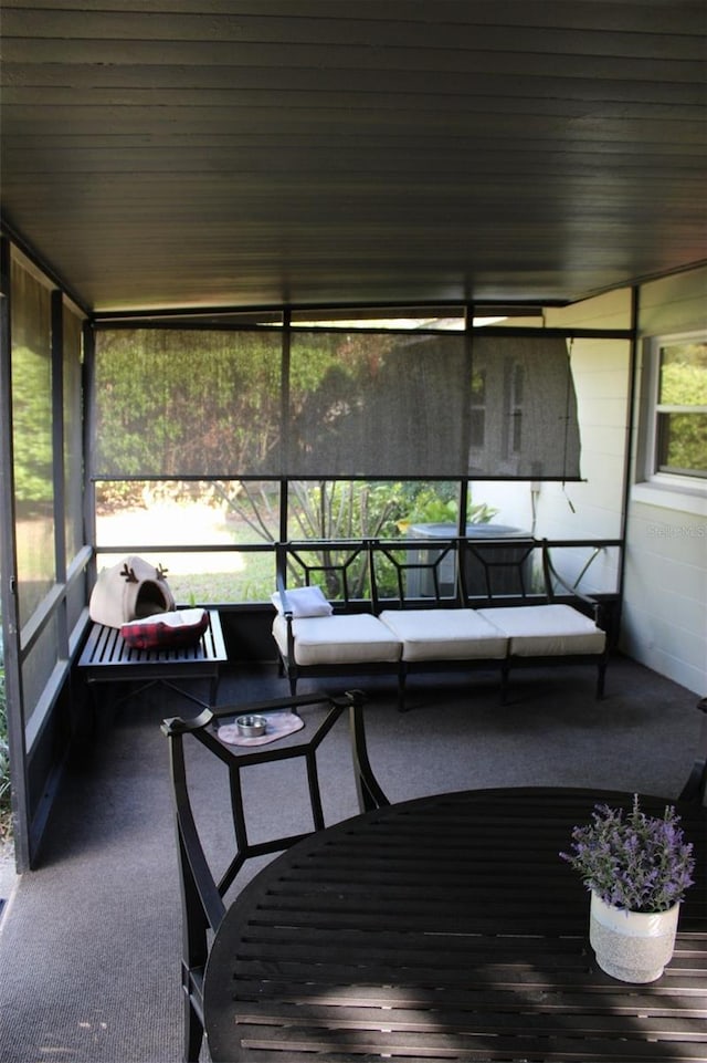 sunroom featuring wood ceiling