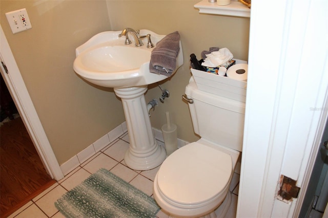 bathroom featuring tile patterned flooring, toilet, and baseboards