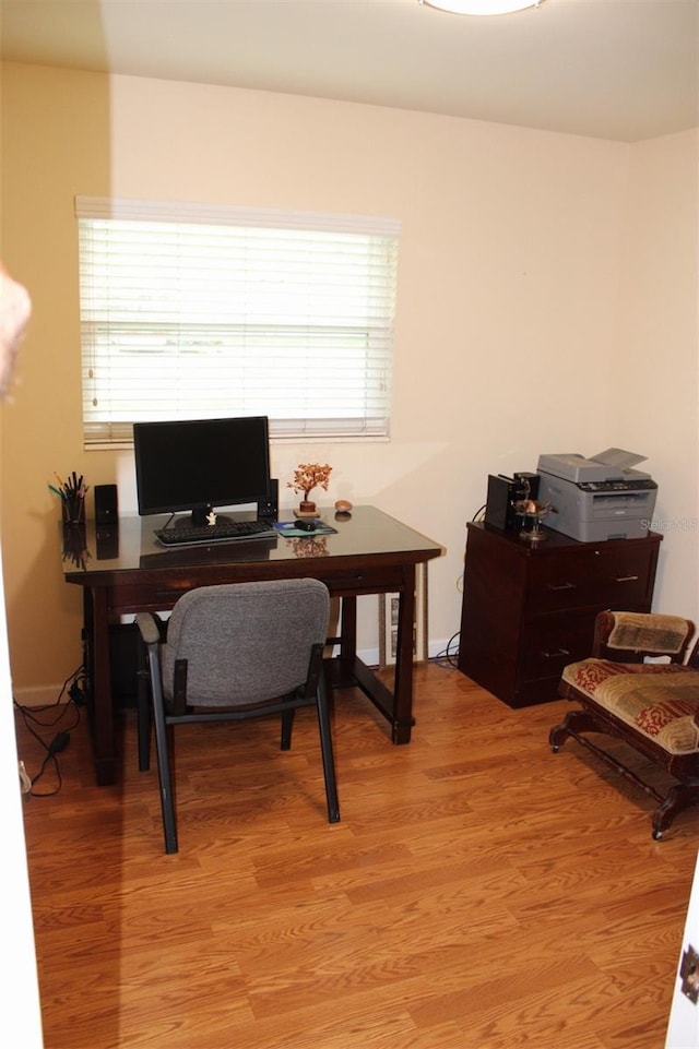 office with light wood-style flooring