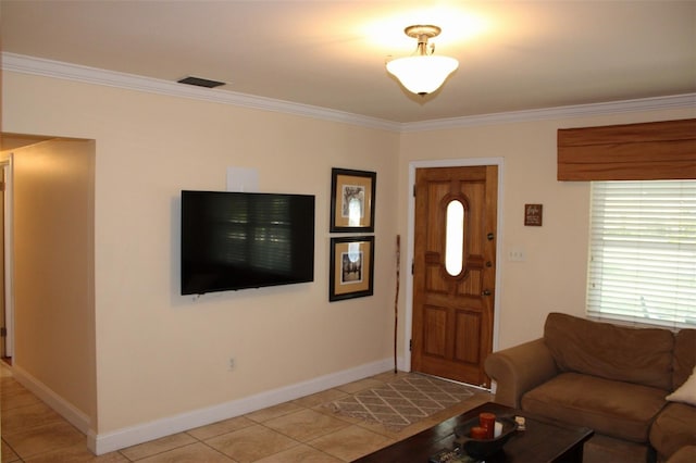 living room with light tile patterned floors, crown molding, and baseboards