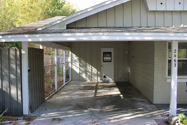 exterior space with a carport and fence