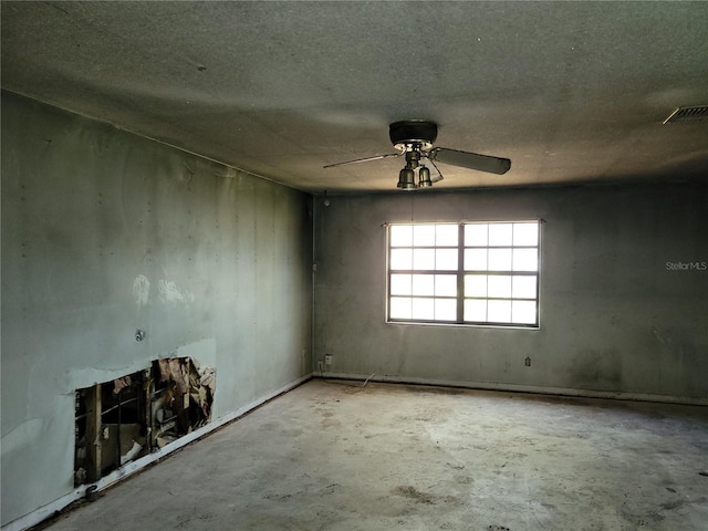 unfurnished room featuring a ceiling fan, visible vents, and concrete flooring