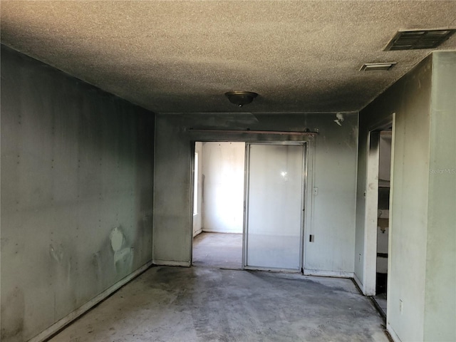 interior space featuring visible vents and a textured ceiling