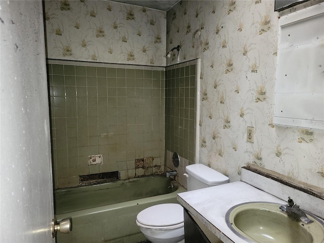 bathroom with shower / bathtub combination, toilet, vanity, and wallpapered walls