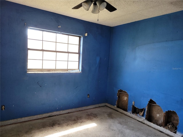 spare room with a ceiling fan and a textured ceiling