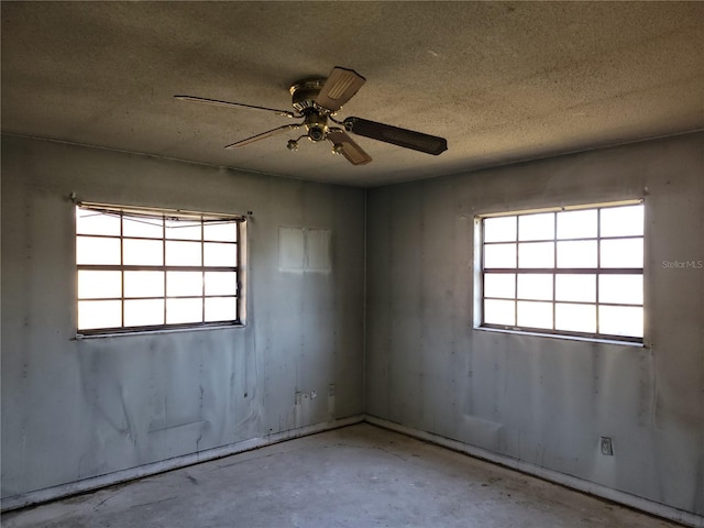 spare room featuring a textured ceiling and ceiling fan