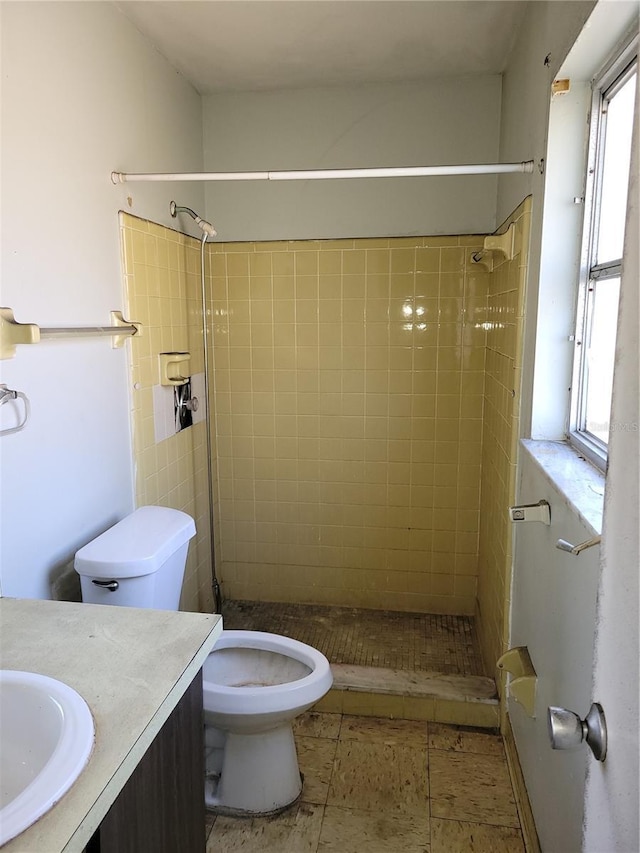 full bathroom featuring vanity, a shower stall, and toilet