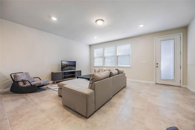 living area with light tile patterned flooring, recessed lighting, and baseboards