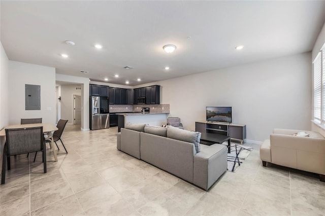 living room with electric panel, baseboards, recessed lighting, and light tile patterned floors